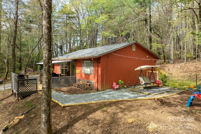 view of outdoor structure with a forest view