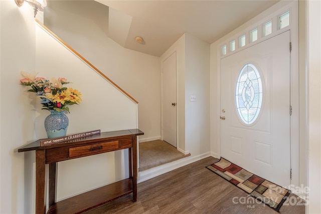 foyer featuring wood finished floors and baseboards