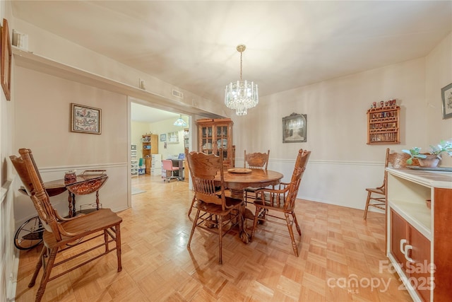 dining space with a chandelier and visible vents