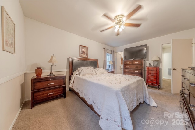 bedroom featuring light carpet, baseboards, and ceiling fan