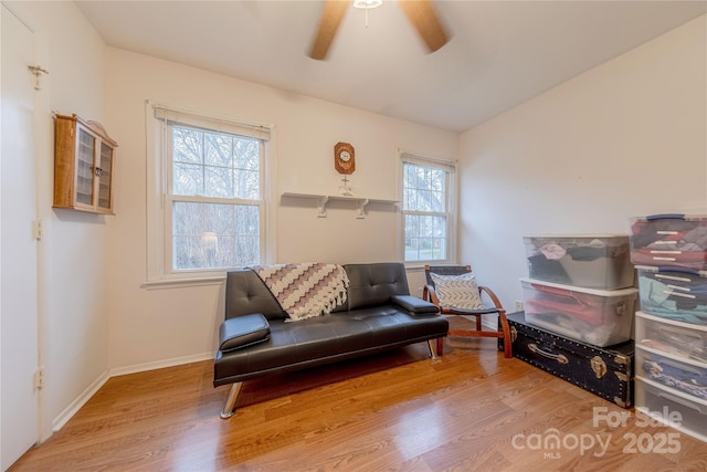 sitting room featuring ceiling fan, lofted ceiling, baseboards, and wood finished floors