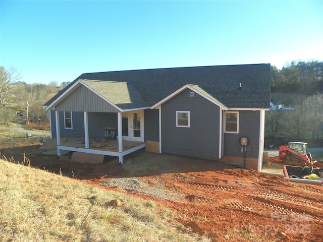 view of front facade with roof with shingles