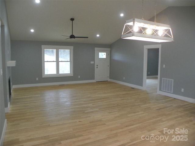 empty room featuring light wood finished floors, baseboards, and visible vents