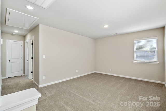 unfurnished room featuring recessed lighting, carpet floors, visible vents, baseboards, and attic access