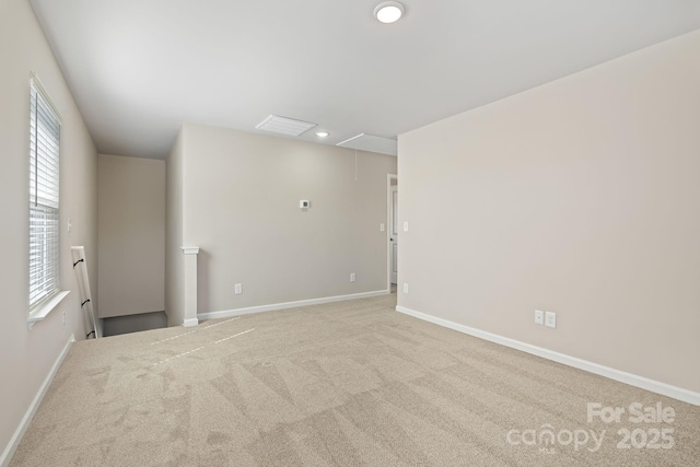 spare room with carpet, attic access, baseboards, and recessed lighting