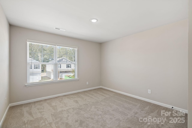 carpeted empty room with recessed lighting, visible vents, and baseboards