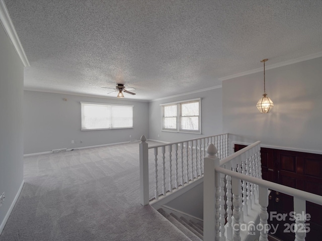 interior space featuring baseboards, a textured ceiling, and ornamental molding