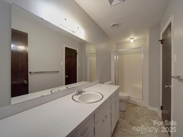 bathroom with visible vents, a shower stall, toilet, vanity, and a textured ceiling