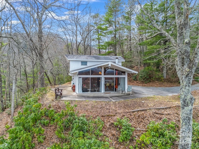 675 Foster Hill Dr, Hendersonville, NC 28739 - back of property featuring driveway and a forest view