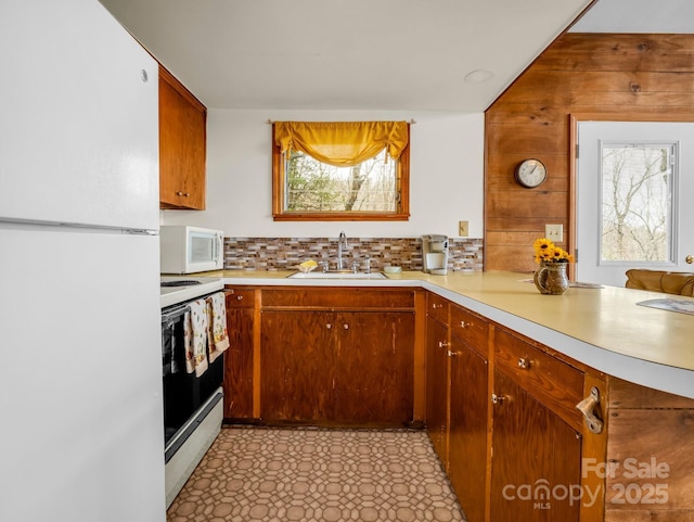 675 Foster Hill Dr, Hendersonville, NC 28739 - kitchen with backsplash, light countertops, a peninsula, white appliances, and a sink