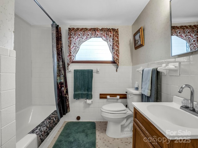 675 Foster Hill Dr, Hendersonville, NC 28739 - full bathroom with a wealth of natural light, a wainscoted wall, toilet, and tile walls