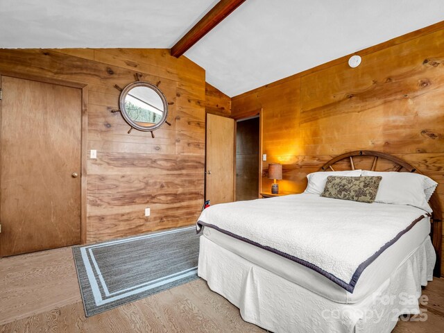 675 Foster Hill Dr, Hendersonville, NC 28739 - unfurnished bedroom featuring lofted ceiling with beams, wooden walls, and wood finished floors