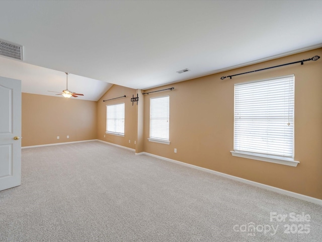 unfurnished room featuring carpet floors, visible vents, and baseboards