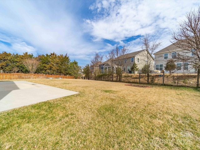 view of yard with a residential view and fence