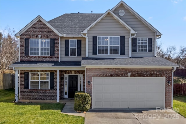 traditional-style home with brick siding, fence, driveway, and an attached garage