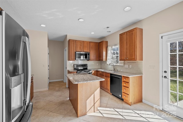 kitchen with a sink, light tile patterned floors, stainless steel appliances, and backsplash