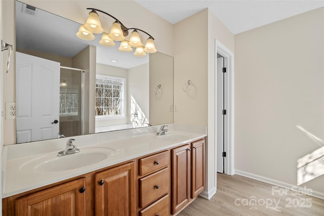 bathroom featuring double vanity, a stall shower, visible vents, and a sink