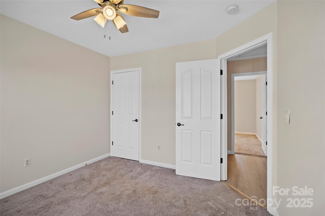 unfurnished bedroom with carpet, ceiling fan, and baseboards