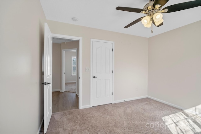 unfurnished bedroom with ceiling fan, carpet, and baseboards