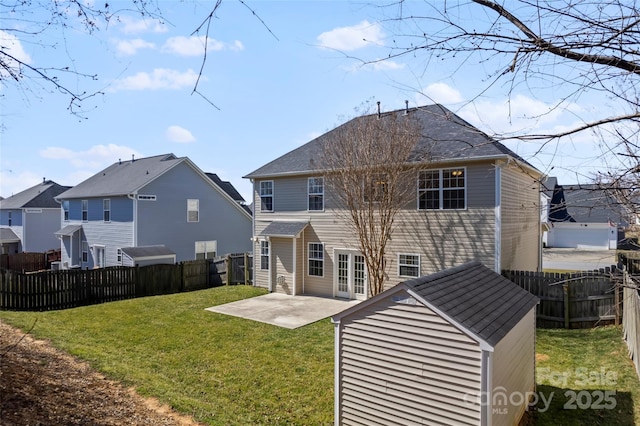 back of house with a patio area, a fenced backyard, and a lawn