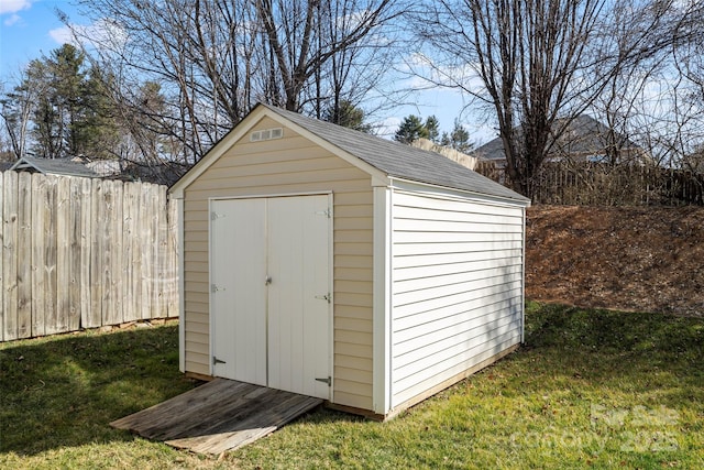 view of shed with fence