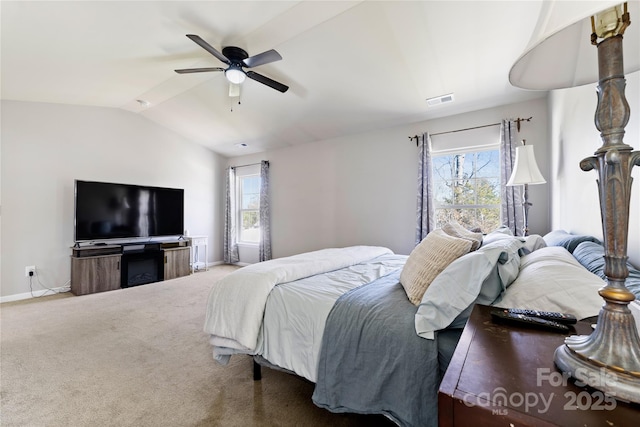 carpeted bedroom featuring lofted ceiling, ceiling fan, visible vents, and baseboards