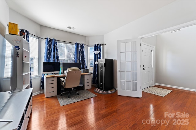 office featuring dark wood-type flooring, visible vents, and baseboards