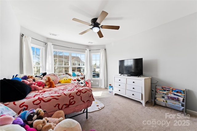 bedroom featuring a ceiling fan, light colored carpet, visible vents, and baseboards