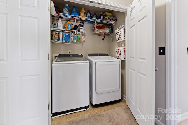 clothes washing area featuring washing machine and dryer and laundry area