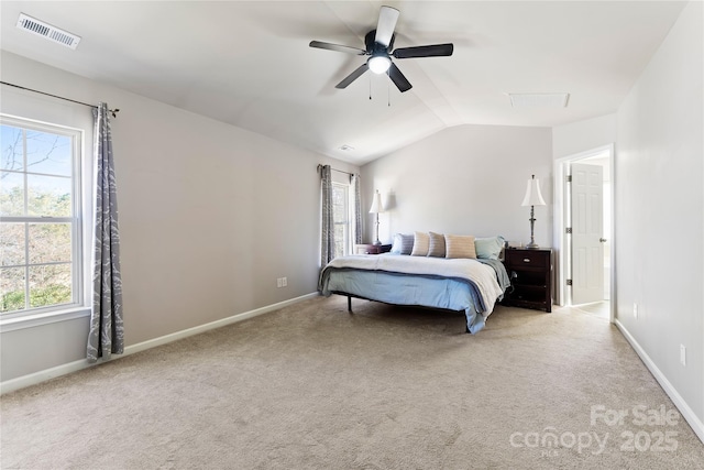 carpeted bedroom with baseboards, visible vents, vaulted ceiling, and a ceiling fan