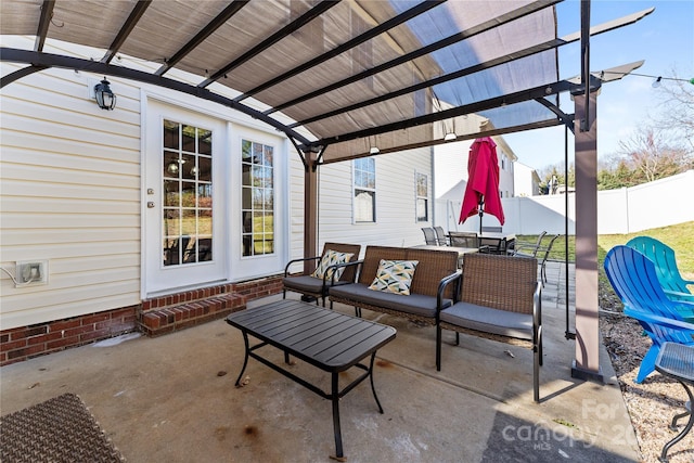 view of patio featuring outdoor dining space, fence, and a pergola