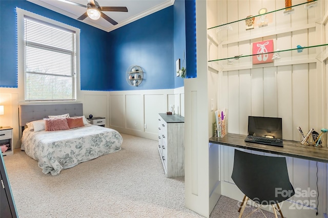 bedroom featuring carpet, ornamental molding, and wainscoting