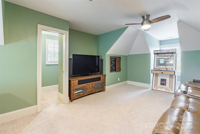 carpeted living room with ceiling fan, vaulted ceiling, plenty of natural light, and baseboards