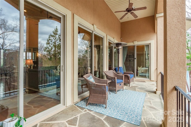 exterior space featuring a sunroom, a patio area, and ceiling fan