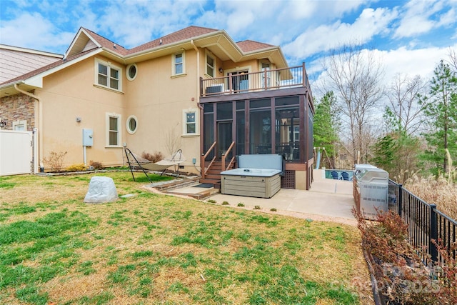 back of house with a patio, a balcony, a sunroom, a fenced backyard, and stucco siding