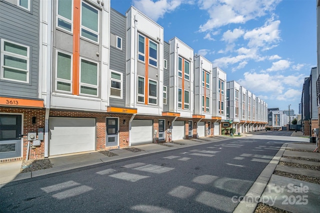 view of building exterior with a residential view and an attached garage