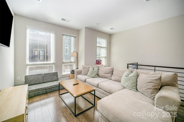 living area featuring visible vents and wood-type flooring