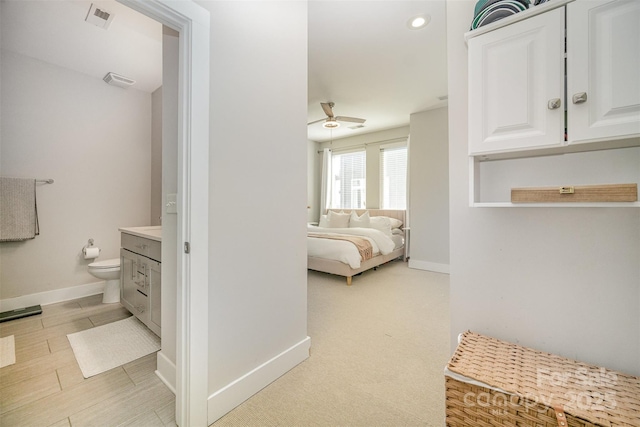 bedroom with recessed lighting, visible vents, connected bathroom, and baseboards