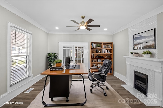 office space with dark wood-type flooring, visible vents, crown molding, and baseboards