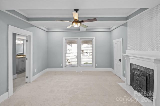 unfurnished living room featuring ceiling fan, light colored carpet, a fireplace, baseboards, and crown molding