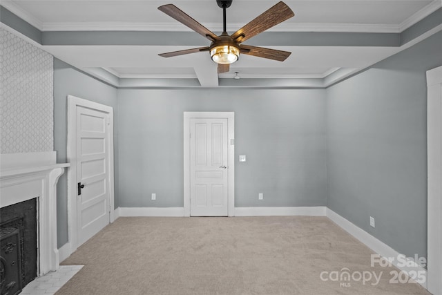 interior space featuring light carpet, a fireplace with flush hearth, baseboards, and crown molding