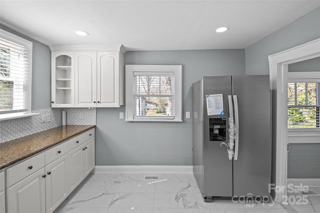 kitchen featuring recessed lighting, baseboards, white cabinets, marble finish floor, and stainless steel fridge with ice dispenser