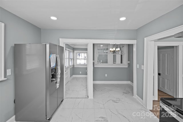 kitchen with marble finish floor, recessed lighting, an inviting chandelier, stainless steel fridge, and baseboards