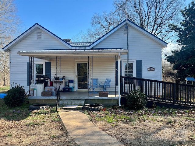 bungalow with metal roof and a porch