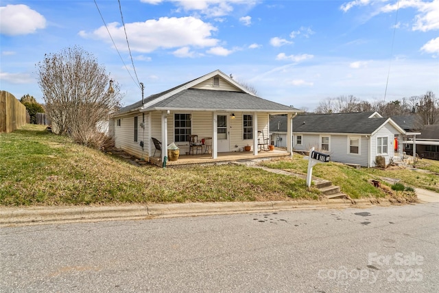 bungalow-style home with fence