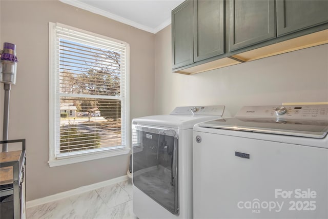 clothes washing area with marble finish floor, washing machine and clothes dryer, cabinet space, ornamental molding, and baseboards