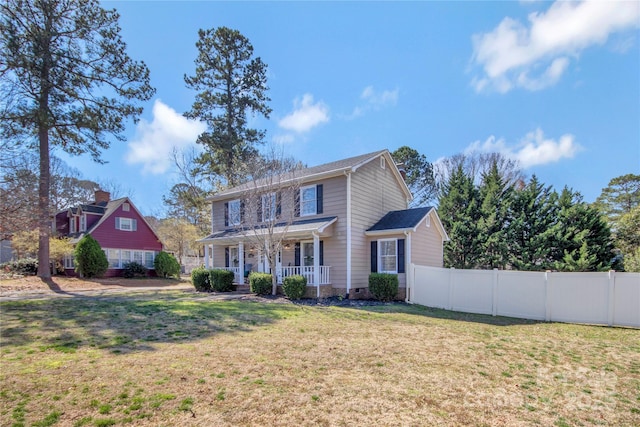 colonial house featuring a porch, a front yard, crawl space, and fence