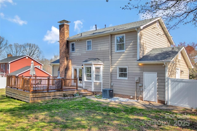 back of house with a deck, a yard, central AC unit, and fence