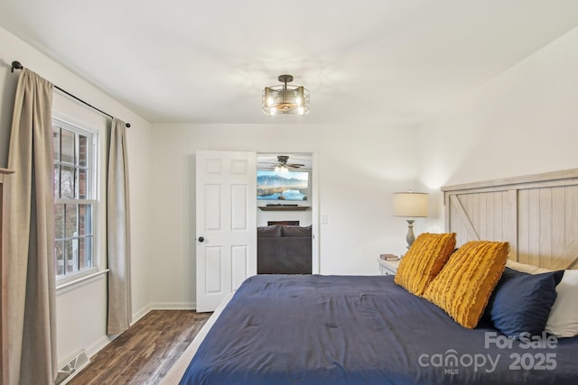 unfurnished bedroom featuring baseboards, visible vents, and wood finished floors