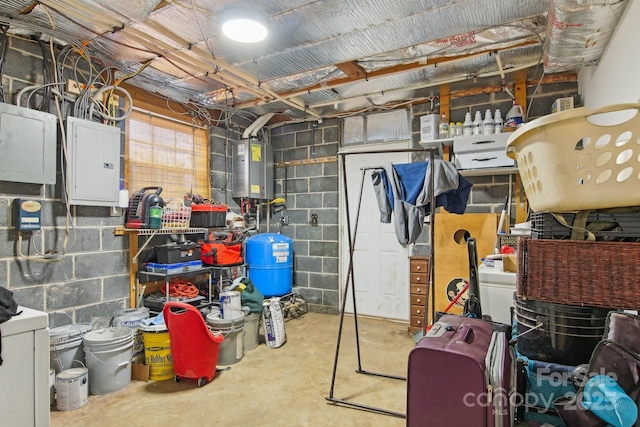 basement featuring tankless water heater, electric panel, and concrete block wall